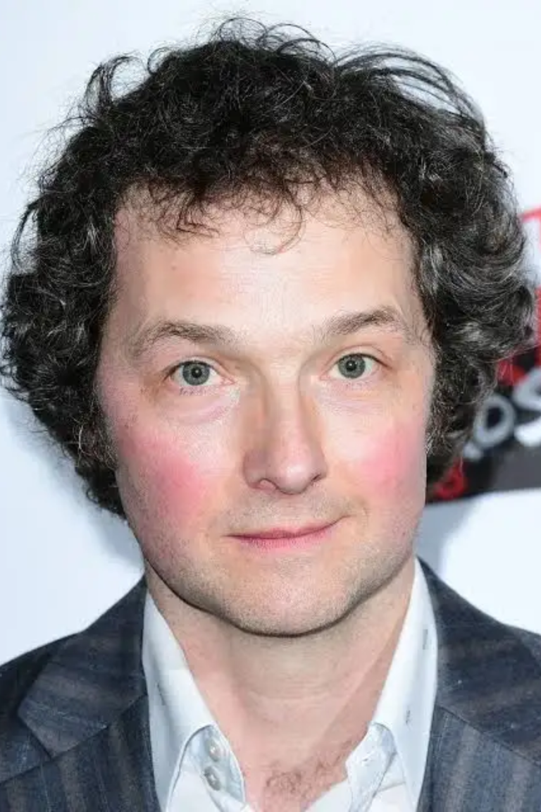 Chris Addison Age , Career, Family, Net Worth, Height Bio 2025. Introduction When you hear the name Chris Addison, you think of clever satire, sharp wit, and a mind that turns politics, culture, and social observations into comedy gold. He didn’t remain only on the stage; he moved into television, film, and directing, showing his versatility across mediums. This article covers Chris’s life story — his early years, rise in stand‑up comedy, work in TV and film, directing projects, recurring themes in his work, personal life, and overall influence. The style is simple and clear so anyone can follow his remarkable journey. Real Name Christopher David Addison is the full name of Chris Addison. He uses this name professionally across his stand‑up, TV, and directing work. Early Life and Education Chris Addison was born on 5 November 1971 in Cardiff, Wales. His family later moved to Worsley, near Manchester, England. He attended Manchester Grammar School, a school known for academic excellence, which likely shaped his early intellectual curiosity. After school, Chris studied English Literature at the University of Birmingham. Originally, he intended to direct theatre but discovered a passion for comedy and performance. His university years exposed him to writing, performance, and analytical thinking — skills that would define his comedic style. Parents and Siblings Chris Addison comes from a supportive family. While detailed public records about his parents and siblings are limited, his upbringing in Wales and later near Manchester provided a cultural blend that influenced his observational humor. Children Chris Addison lives in South East London with his wife and two children. He has mentioned balancing family life with his creative projects, showing how he manages both career and personal commitments. Age, Weight, Height, and Physical Appearance Chris Addison is 51 years old as of 2025. Public sources do not provide detailed statistics on weight and height, but he maintains a professional presence on screen and stage, often presenting a sharp, approachable appearance in his comedy and TV roles. Before Fame Chris began performing stand‑up comedy in the mid-1990s. He gained early recognition at the Edinburgh Festival Fringe, where his solo shows, including Chris Addison and The Ape That Got Lucky, were nominated for awards. These early performances were lecture-style, blending satire, fact, and wit — a style he would carry into television and radio. Career Stand‑Up Comedy Chris Addison is best known initially for his stand-up comedy. His solo shows often feature a lecture format, combining intellectual commentary, satire, and performance. Notable shows include: The Ape That Got Lucky Civilisation These performances were adapted for BBC Radio 4, earning critical acclaim. His approach combines knowledge with humor, delivering content that educates and entertains simultaneously. Television and Radio Chris gained fame in radio and television through satire and panel shows: The Department (BBC Radio 4) — Co-writer and performer alongside John Oliver and Andy Zaltzman. The Thick of It (BBC TV, 2005–2012) — Role as Ollie Reeder, a political aide, brought him critical acclaim. Mock the Week (2011–2013) — Regular panelist, showcasing quick improvisational wit. Notable Works Table 1: Stand-Up, Radio, and TV Year Project Role/Contribution Notes 1998 Edinburgh Fringe “Chris Addison” Stand-up show First major solo show, Perrier nomination 2005 The Department (Radio) Co-writer & performer Satirical series on BBC Radio 4 2005–2012 The Thick of It (TV) Actor (Ollie Reeder) Political satire, critical acclaim 2011–2013 Mock the Week (TV) Panellist Regular panel show appearances Acting Roles Chris Addison has appeared in both film and television: In the Loop (2009) — Played Toby Wright, a film spin-off of The Thick of It. Doctor Who (Series 8) — Guest appearances expanding his screen versatility. Other cameo roles in UK television series. Writing and Directing Chris expanded into writing and directing, becoming recognized behind the camera: Co-created and directed multiple TV projects. Directed episodes of Veep (HBO), winning the DGA Award for Outstanding Directing – Comedy Series in 2016 and receiving a Primetime Emmy nomination. Directed feature films such as The Hustle (2019). Selected Film and Director Table 2: Key Work Behind the Camera Year Project Role Notes 2013 The Look of Love Actor (Tony Power) Film acting role showcasing versatility 2015–2016 Veep (TV) Director & Executive Producer Multiple episodes, award-winning 2019 The Hustle Director Major feature film directing credit 2024+ Tall Tales & Murder (upcoming) Co-creator/Director New project in TV comedy, ongoing creative path Social Media Presence Chris Addison maintains professional engagement online, often using social media to promote projects, share interviews, and connect with fans. He is active on platforms like Twitter and LinkedIn for professional communication. Nationality and Religion Chris Addison is British, born in Wales and raised in England. Public sources do not provide information about his religious affiliation. Legacy and Impact Chris Addison has shaped British comedy and political satire, blending stand-up, television, film, writing, and directing. His work: Offers intellectual satire on politics and culture. Bridges performance and directing, influencing upcoming comedians and directors. Expands the audience for intelligent humor, balancing wit with educational insight. Hobbies Chris has interests outside comedy, including: Writing columns for The Guardian (finance column “Funny Money”) Participating in opera performances (L’Étoile at the Royal Opera House) Hosting arts-related events and workshops Favorite Thing Chris Addison values intelligent humor and projects that combine wit with substance, often stating in interviews that satire is most effective when informative and entertaining. Interesting Facts Early in his career, Chris planned to direct theatre before choosing comedy. His radio and TV collaborations include notable names like John Oliver, Andy Zaltzman, and Armando Iannucci. He won a Directors Guild of America award for work on Veep, a rare achievement for a UK comedian turned director. Summary Chris Addison is a multi-talented performer, writer, and director whose career spans stand-up, TV, radio, film, and directing. His intelligent, satirical style combines wit with deep observation of politics and culture. From his Edinburgh Fringe shows to acting roles in The Thick of It and In the Loop, to directing acclaimed projects like Veep, Addison exemplifies versatility and commitment to craft. He balances family life with creative work, contributing to public discourse through satire, writing, and interviews. His career offers inspiration for comedians, actors, directors, and audiences alike, showing that intelligence, humor, and adaptability create lasting impact. FAQs What is Chris Addison’s background and early career? Chris Addison was born in 1971 in Cardiff, grew up near Manchester, studied English Literature at the University of Birmingham, and began performing stand-up comedy in the mid-1990s. What major TV and film roles has Chris Addison had? He is best known as Ollie Reeder in The Thick of It, for appearing in In the Loop, and for directing episodes of Veep. How did Chris Addison transition from stand-up to directing? Chris expanded from stand-up to radio and TV acting, then into writing and directing behind the camera. His work on Veep marked a significant career shift. What themes and style are common in Chris Addison’s work? He often focuses on politics, power, and institutional satire, using intelligent humor grounded in his literature and theater background. What upcoming projects should we watch for from Chris Addison? His agency lists Tall Tales & Murder (BBC/RTE) for 2026, where he is co-creator and director. He may also return to acting roles in TV or film.